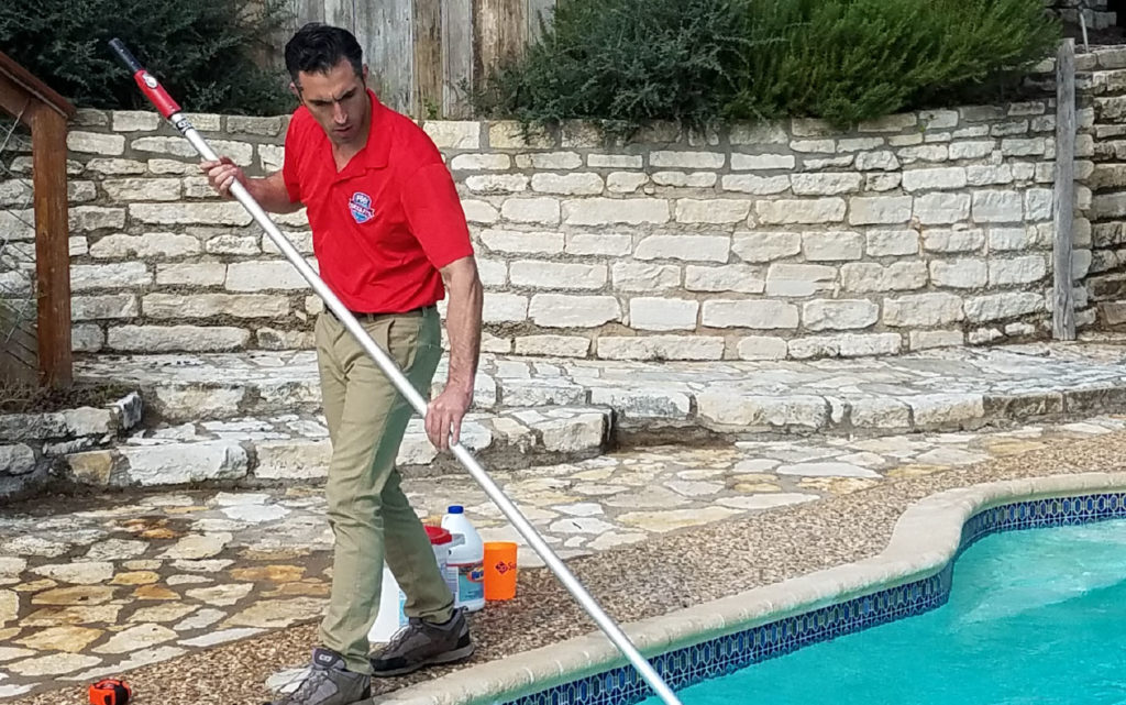 Owner Matt Smith cleaning a pool with a pool net