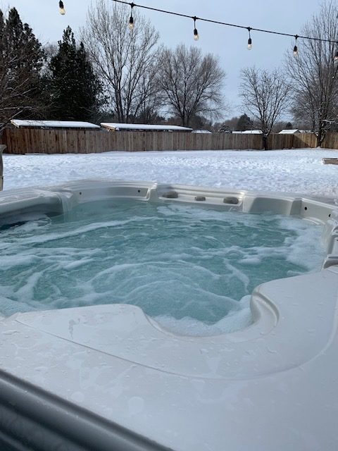 Clean hot tub in snowy backyard 
