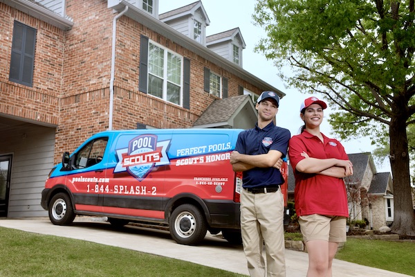 Pool Scouts technicians smiling back to back in front of a Pool Scouts van at a customer's home