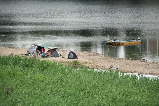 Tents along the Cape Fear River and person kayaking
