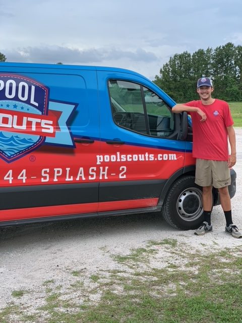 Jacob Ivey standing by Pool Scouts van