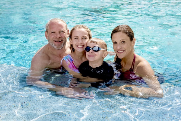 Happy family in a clean pool serviced by Pool Scouts of Cedar Park