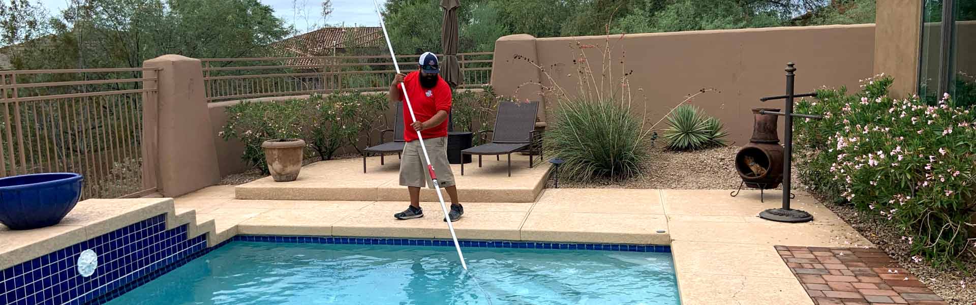Pool Scouts technician using vacuum in swimming pool