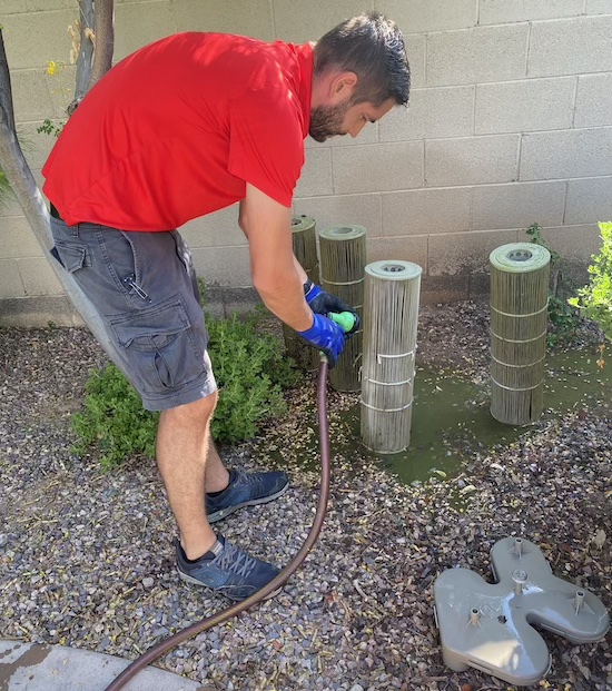 Pool Scouts technician cleaning off a pool filter