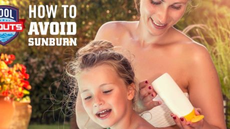 Mom putting sunscreen on daughter by pool