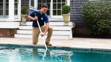 Pool Scouts pool cleaner cleaning a customer's pool