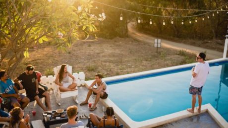 Friends hanging out by pool at dusk