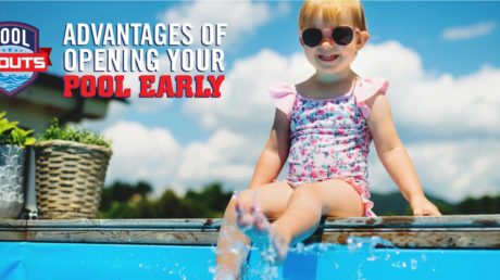 Little girl splashing her feet in a pool