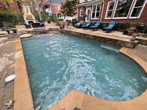 Clean, blue swimming pool in backyard