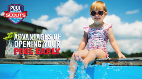 Little girl sitting on edge of pool in sunglasses