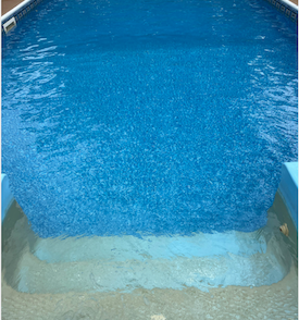 Bright blue, clean swimming pool that had pool cleaning service by Pool Scouts of McKinney