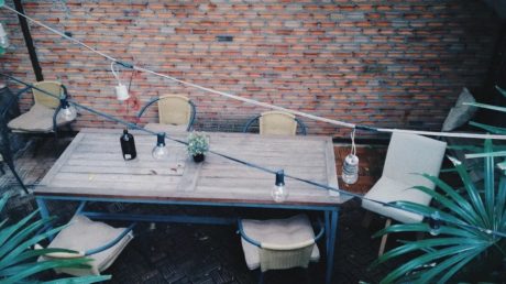 Back patio with brick wall and table and chairs