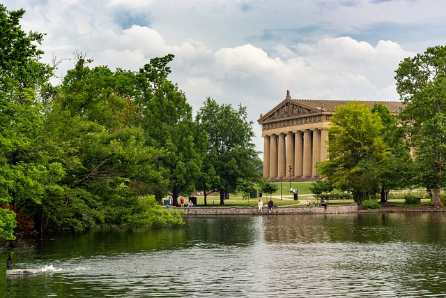 The parthenon in Nashville surrounded by trees and a lake