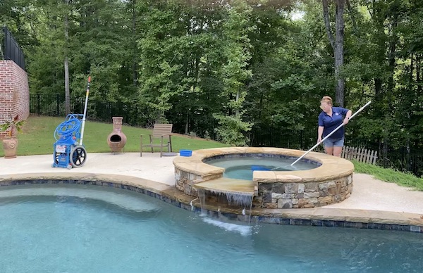 Pool Scouts owner Heather cleaning pool