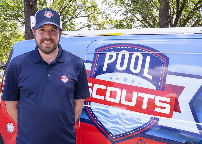 Pool Scouts owner Chris Webb smiling next to Pool Scouts van