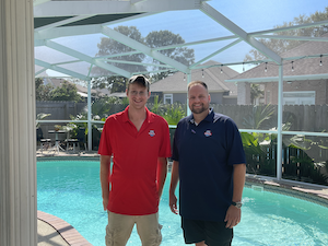 Cobi and Matt in front of a pool