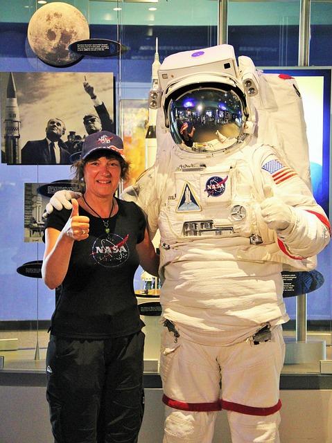 Woman in Nasa shirt posing with astronaut at Kennedy Space Center