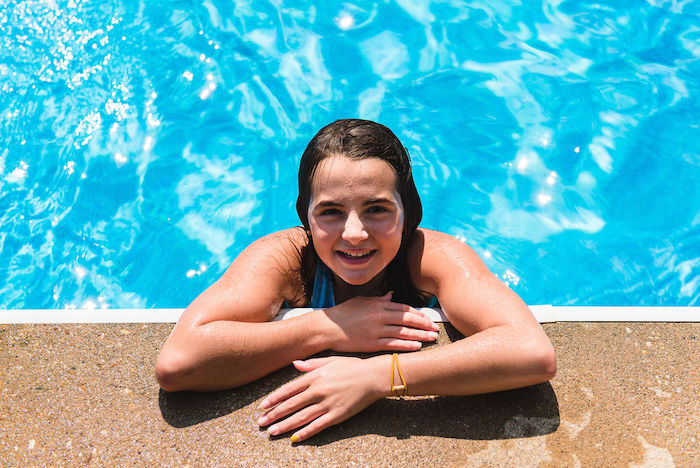 Little girl happy in a clean swimming pool