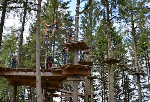 People climbing a ropes course in Virginia Beach