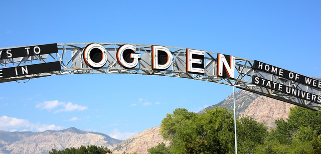 The entrance sign into Ogden, Utah with mountains in background