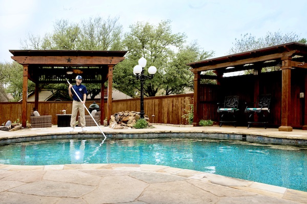 Pool technician cleaning a customer's pool in Salt Lake City