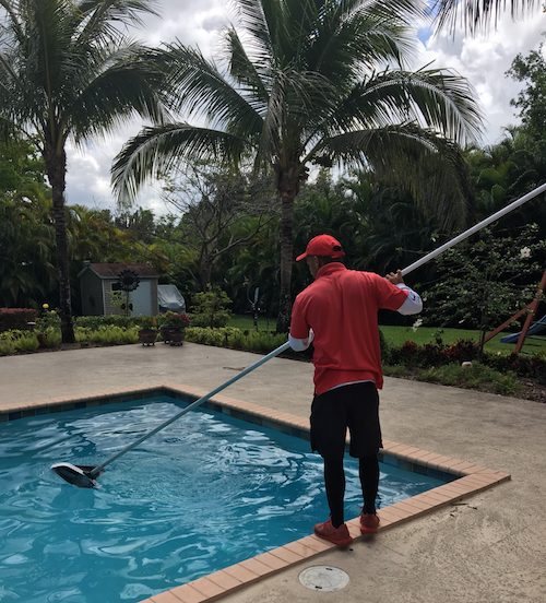 Pool technician cleaning a pool