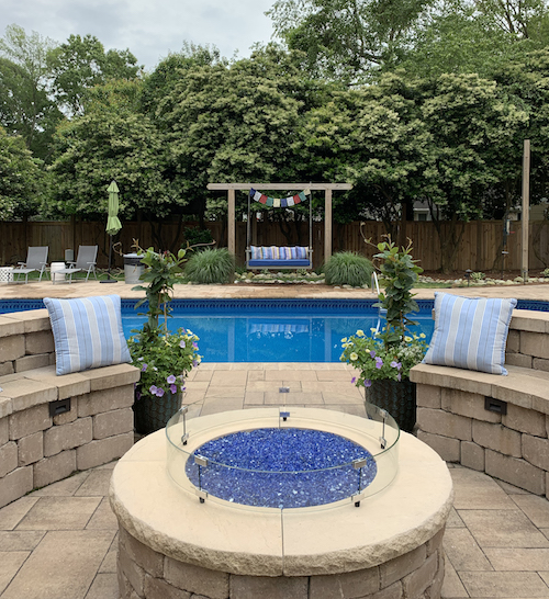 Fire pit in beautiful backyard with clean pool