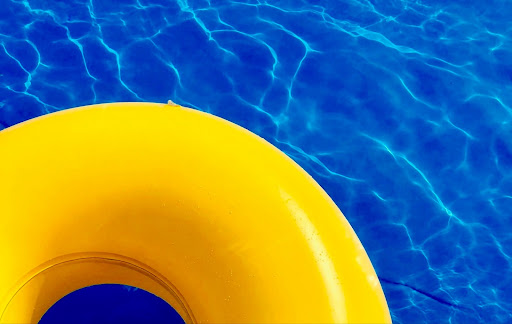Yellow pool float in a bright blue swimming pool