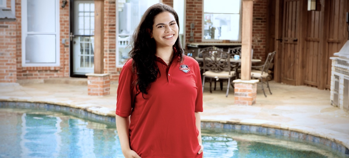 Pool Scouts technician in front of a clean swimming pool to highlight the benefits of using pool service