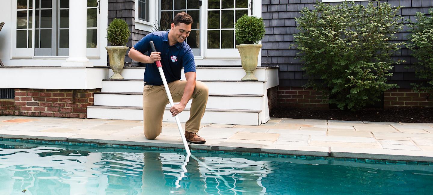 Pool Scouts pool cleaner cleaning a customer's pool